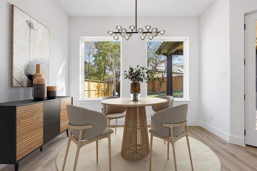 Dining room with light wood-style floors and a chandelier Dining room with light wood-style floors and a chandelier