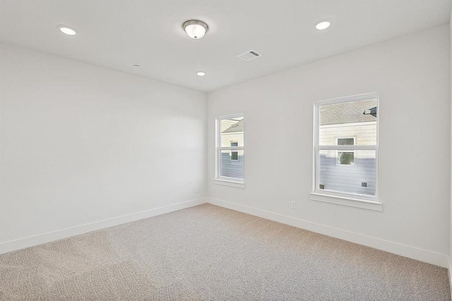 Unfurnished room with recessed lighting, baseboards, and light carpet