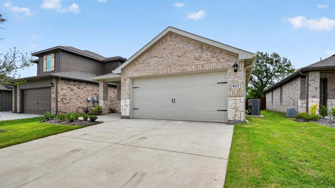 Front exterior of a new home in Hanolley Hills, Sherman, TX, highlighting curb appeal (Image 2). Front exterior of a new home in Hanolley Hills, Sherman, TX, highlighting curb appeal (Image 2).