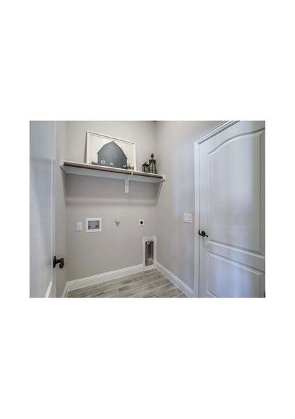 Laundry room with hookup for a washing machine, light hardwood / wood-style flooring, hookup for a gas dryer, and electric dryer hookup