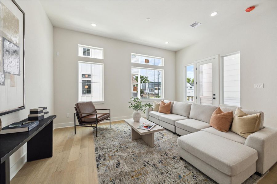 Bright and inviting living room with abundant natural light, modern design, and ample seating—perfect for relaxation and entertaining.
