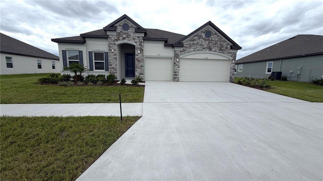 Front exterior of a new home in Applewood Reserve, Lakeland, FL, highlighting curb appeal (Image 1). Front exterior of a new home in Applewood Reserve, Lakeland, FL, highlighting curb appeal (Image 1).