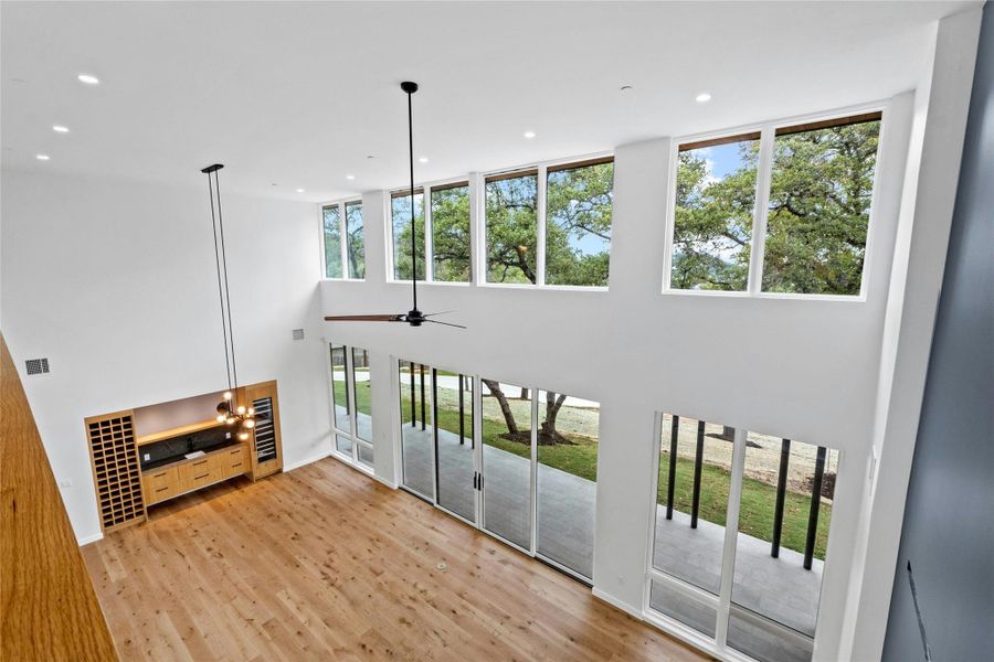 View from upper balcony overlooking the great room. Double level of windows captures the outdoors and the majesty of the setting.