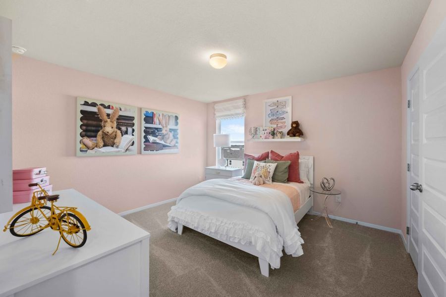 An interior image with pink painted walls, brown carpet, a bed with white bedding,and cartoon animal art.