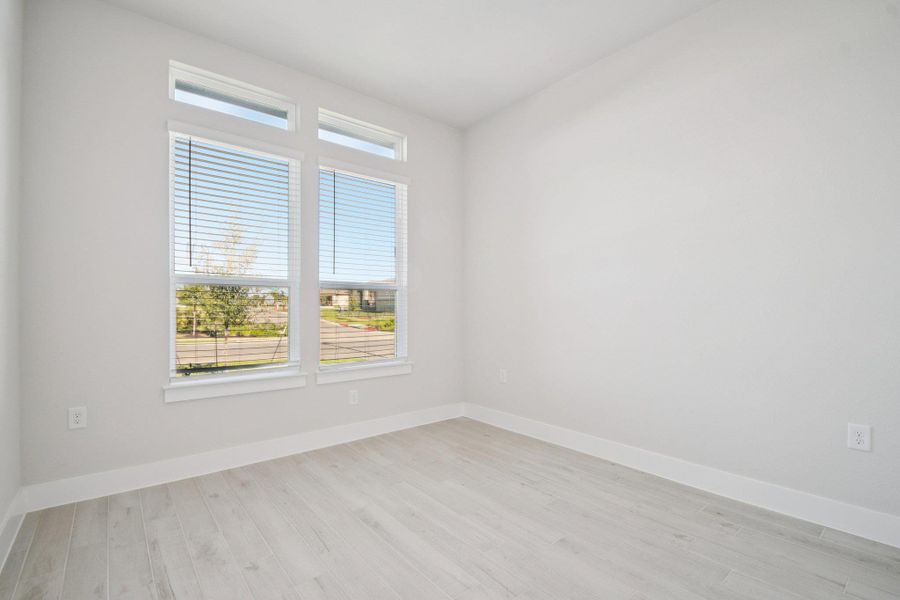 Unfurnished room featuring light wood-style flooring and baseboards
