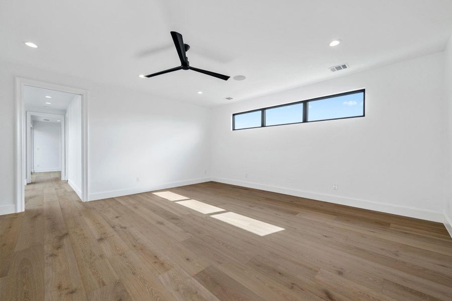 Spare room featuring a ceiling fan, light wood-style flooring, and recessed lighting