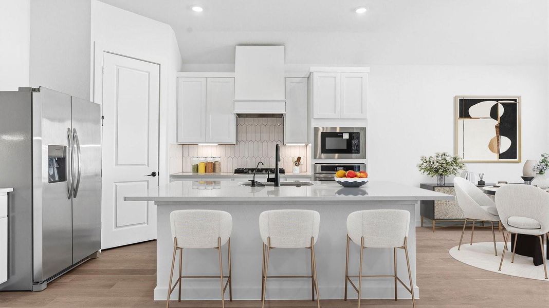 Kitchen adorned with painted cabinets seamlessly integrated into an open dining area layout.