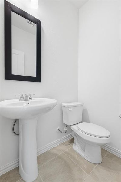 Bathroom featuring light tile patterned floors and baseboards