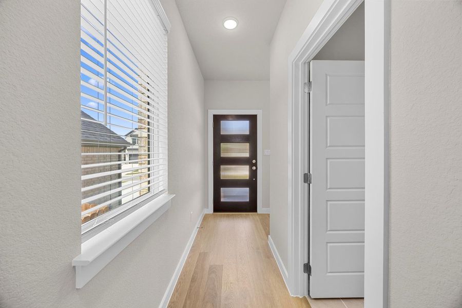 A welcoming entryway with recessed lighting and light wood flooring. A welcoming entryway with recessed lighting and light wood flooring.