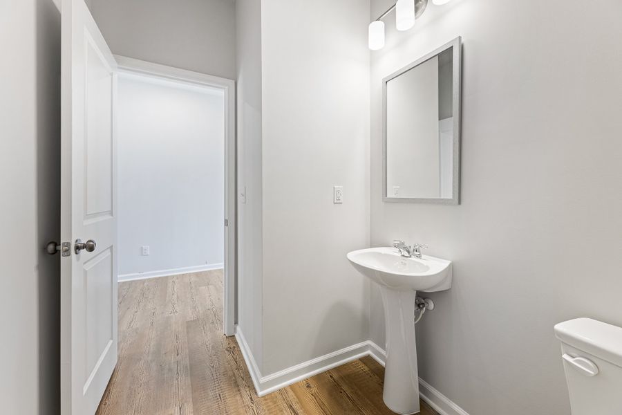 A bathroom with a sink and a mirror. A bathroom with a sink and a mirror.