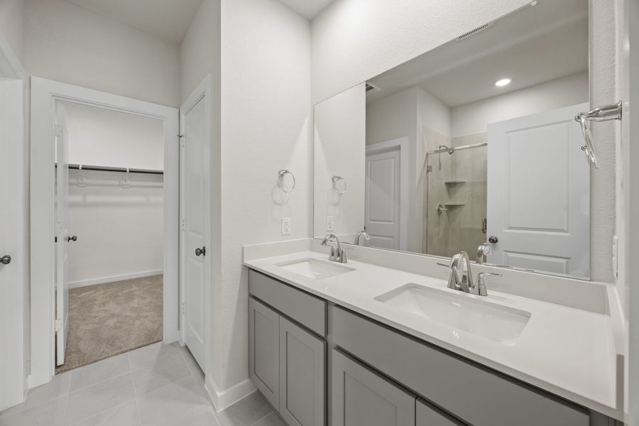 A bathroom with a large mirror.
