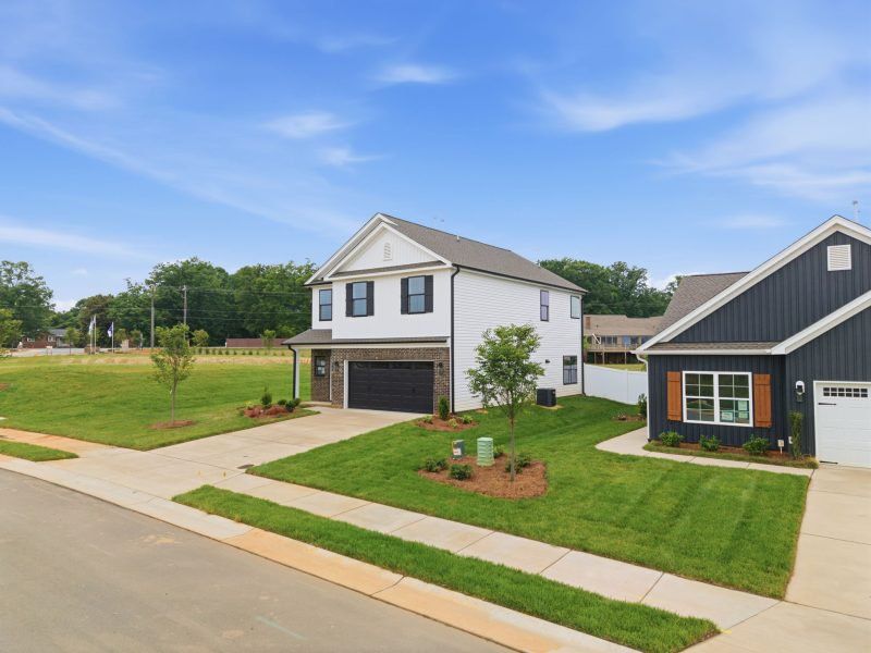 Front exterior of a new home in Sullivans Reserve, Walkertown, NC, highlighting curb appeal (Image 25). Front exterior of a new home in Sullivans Reserve, Walkertown, NC, highlighting curb appeal (Image 25).