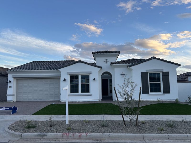Front exterior of a new home in Escena at Blossom Rock, Apache Junction, AZ, highlighting curb appeal (Image 1). Front exterior of a new home in Escena at Blossom Rock, Apache Junction, AZ, highlighting curb appeal (Image 1).