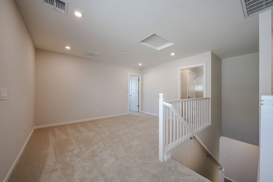 A hallway with white railings. A hallway with white railings.