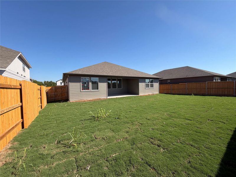 Back of house featuring a patio, a shingled roof, and a fenced backyard Back of house featuring a patio, a shingled roof, and a fenced backyard