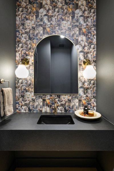 A chic vanity with a striking animal-themed accent wall adds character to this well-appointed bathroom. A chic vanity with a striking animal-themed accent wall adds character to this well-appointed bathroom.
