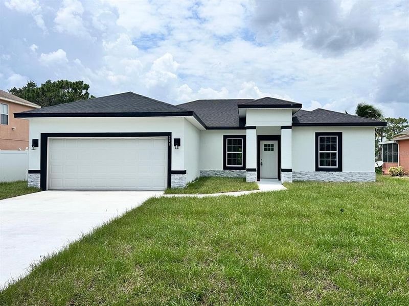 Front exterior of a new home in , Poinciana, FL, highlighting curb appeal (Image 16). Front exterior of a new home in , Poinciana, FL, highlighting curb appeal (Image 16).