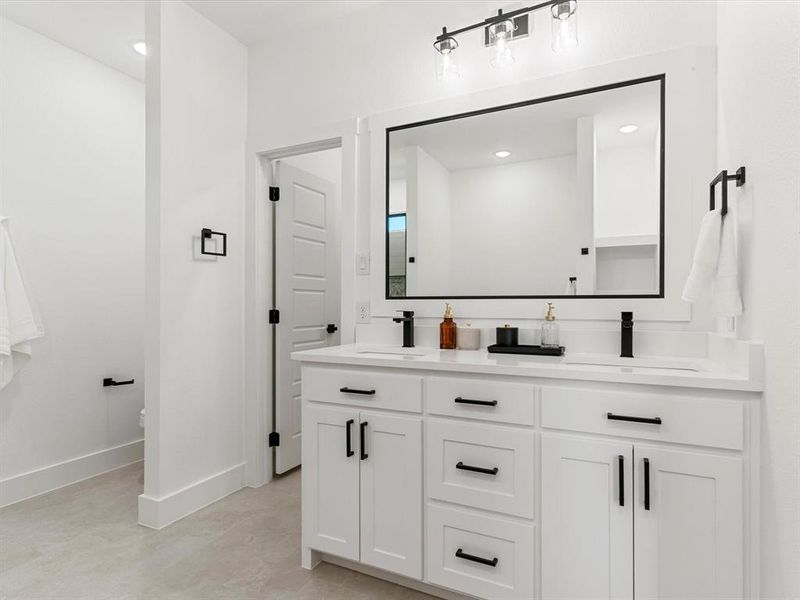 Bathroom with double vanity and recessed lighting