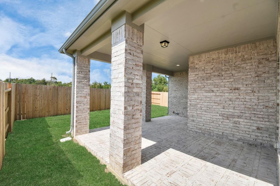 Experience outdoor living at its finest on this expansive covered patio, thoughtfully designed for BBQs and delightful outdoor dining. Sample photo of completed home with similar floor plan. Actual colors and selections may vary. Experience outdoor living at its finest on this expansive covered patio, thoughtfully designed for BBQs and delightful outdoor dining. Sample photo of completed home with similar floor plan. Actual colors and selections may vary.