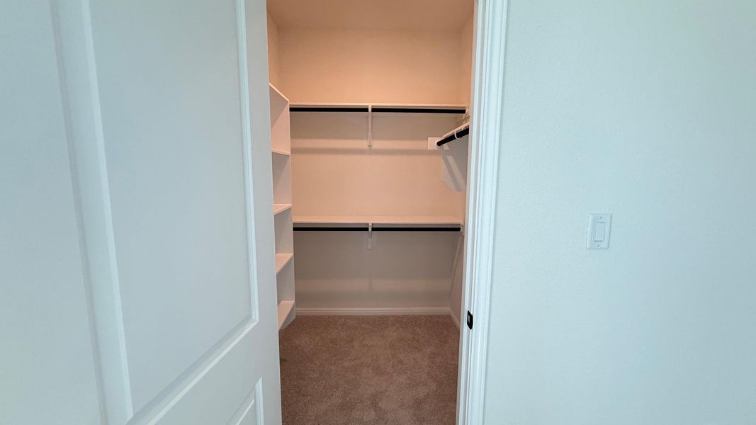 Well-organized walk-in closet offers ample storage with integrated shelving and hanging rods. Well-organized walk-in closet offers ample storage with integrated shelving and hanging rods.