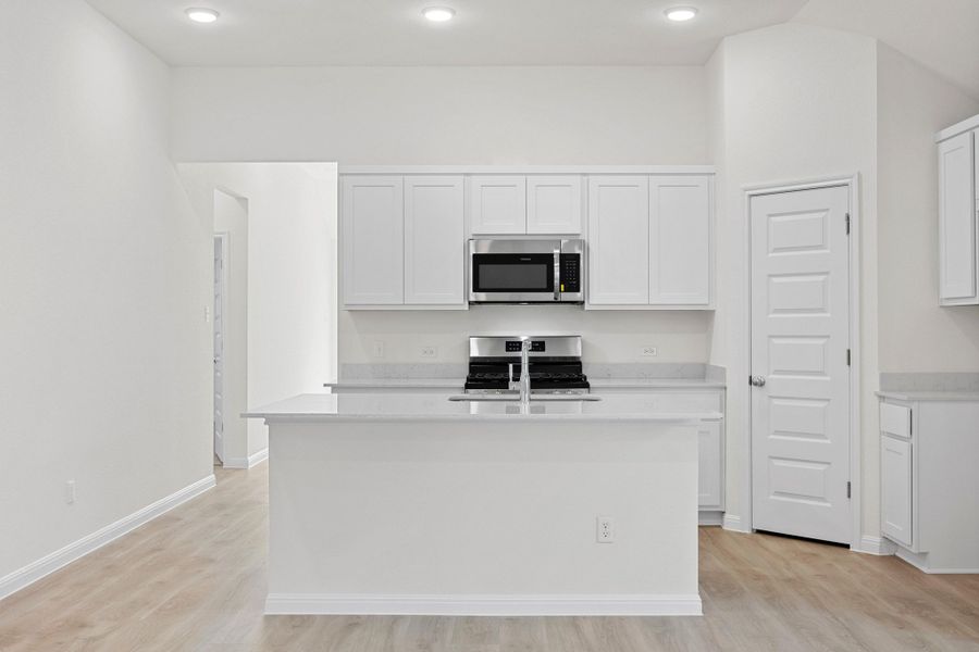 Kitchen in the Cypress home plan by Trophy Signature Homes - REPRESENTATIVE PHOTO