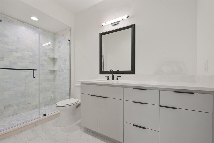 This is the bath on the third floor complete with walk-in shower and ample storage.