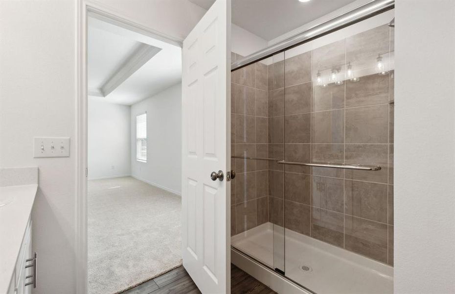 Elegant owner's bathroom with oversized shower*real home pictured