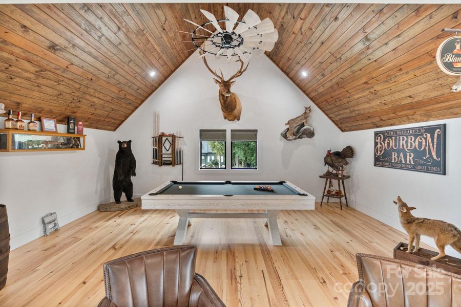 Pool table anchors the recreational purpose of the room Pool table anchors the recreational purpose of the room