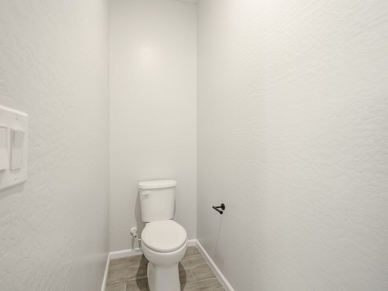A toilet in a bathroom. A toilet in a bathroom.