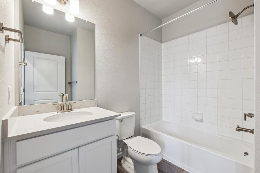 A bathroom with a tub sink and toilet. A bathroom with a tub sink and toilet.