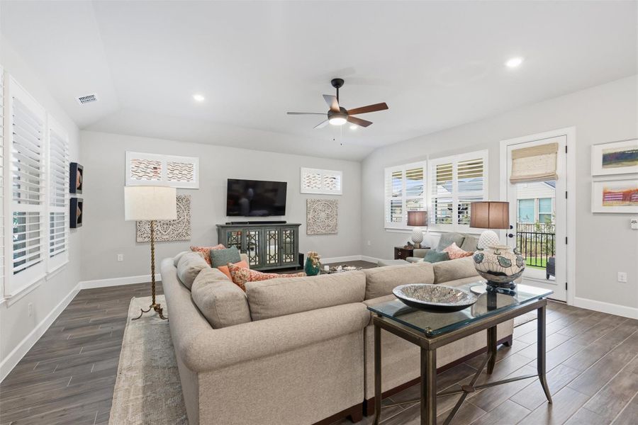 Expansive family room at the rear of the home off the kitchen/dining areas features numerous windows and a wood framed glass door to the covered patio. Notice the 3 1/2" plantation shutters in this room and throughout the home. The natural light welcomes you into the home and the plantation shutters can be closed for privacy or television viewing. Expansive family room at the rear of the home off the kitchen/dining areas features numerous windows and a wood framed glass door to the covered patio. Notice the 3 1/2" plantation shutters in this room and throughout the home. The natural light welcomes you into the home and the plantation shutters can be closed for privacy or television viewing.