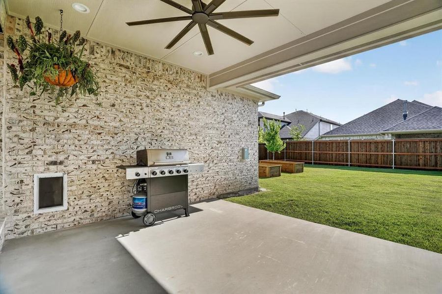 Covered patio featuring a concrete slab and a ceiling fan Covered patio featuring a concrete slab and a ceiling fan