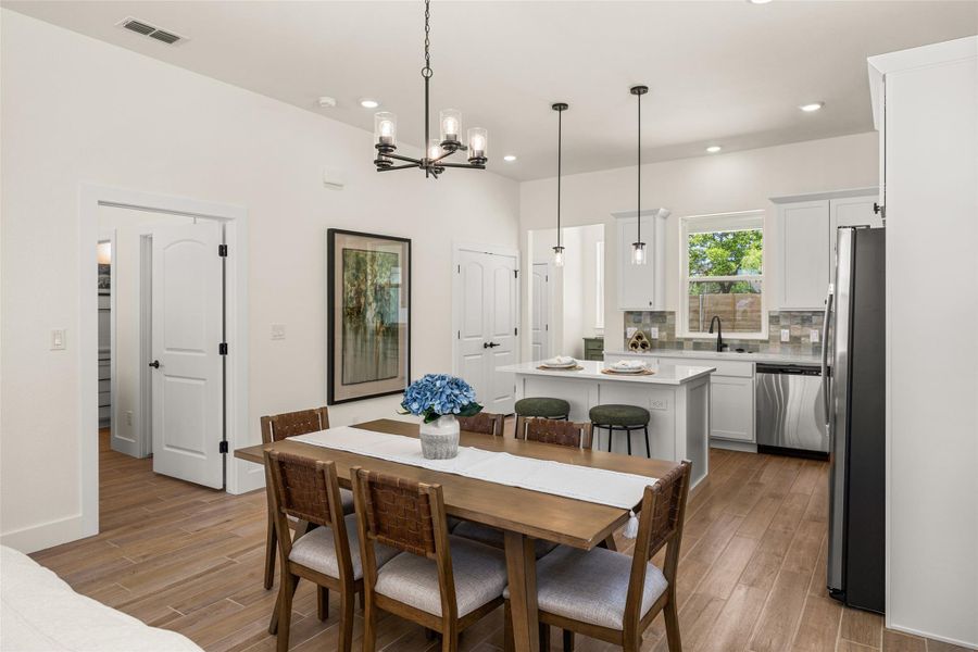 An open-concept living space integrates a well-appointed kitchen with a comfortable dining area.