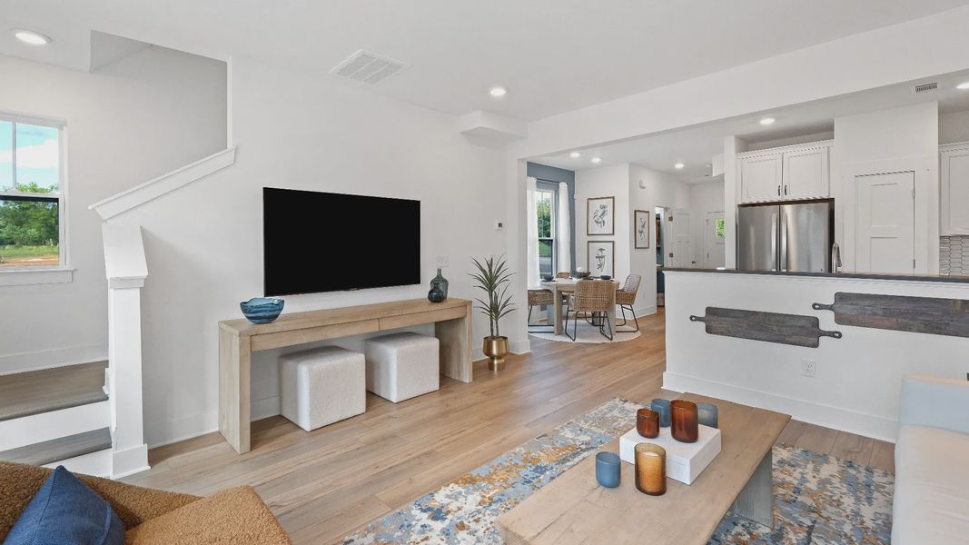 First-rate family room of The Churchill Design with thoughtful layout and superior connection to kitchen and dining spaces
