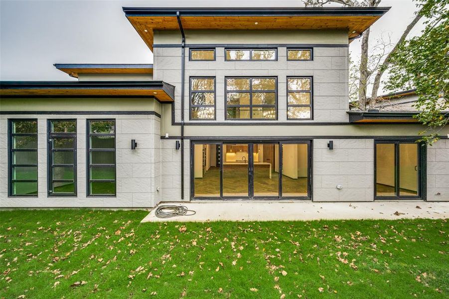 Back of house featuring a yard Back of house featuring a yard