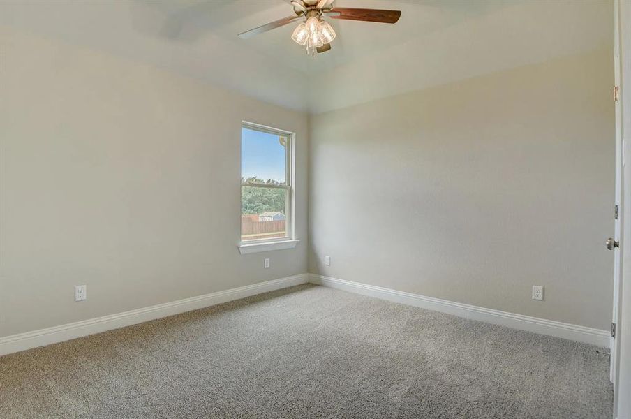 Unfurnished room with light colored carpet, ceiling fan, and baseboards