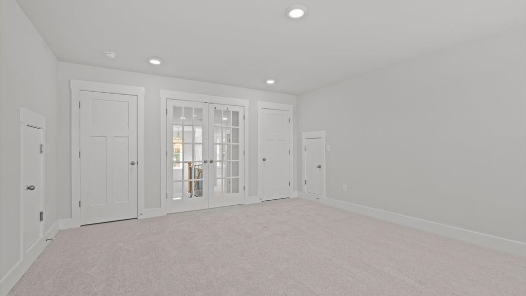 Vibrant carpeted bonus room offering flexibility as a study nook, game room, or second family space