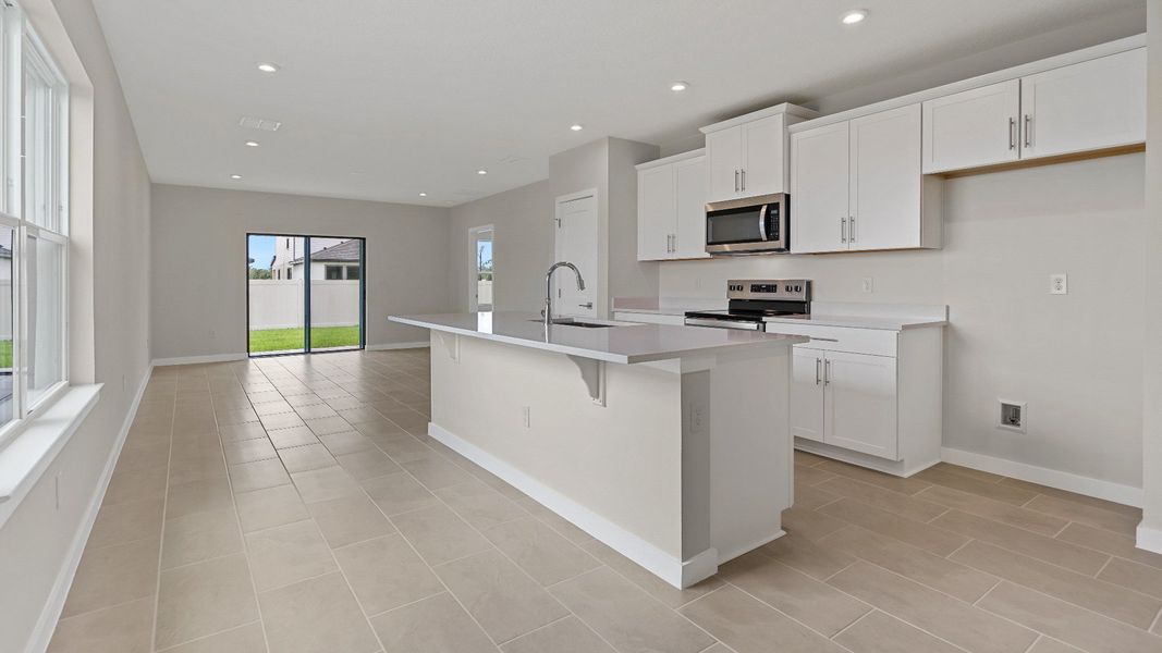 The Atlantic by DRB Homes offers a bright open-concept kitchen with island seating—perfect for entertaining in Lakeland, FL. The Atlantic by DRB Homes offers a bright open-concept kitchen with island seating—perfect for entertaining in Lakeland, FL.