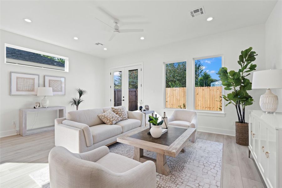 The living area creates a picture-perfect scene, where natural light, warm finishes, and open design come together in harmony.