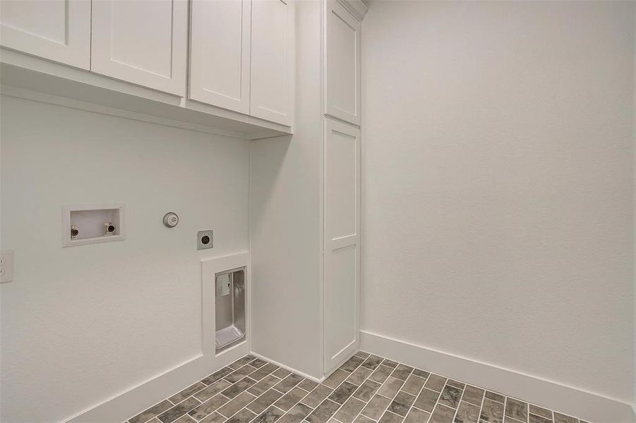 Laundry room featuring washer hookup, hookup for an electric dryer, and cabinets