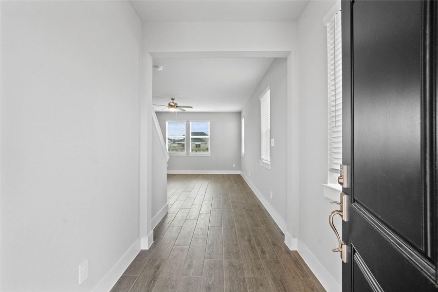 Step inside a bright, open foyer featuring beautiful wood-look tile flooring that seamlessly flows into the main living areas. Step inside a bright, open foyer featuring beautiful wood-look tile flooring that seamlessly flows into the main living areas.