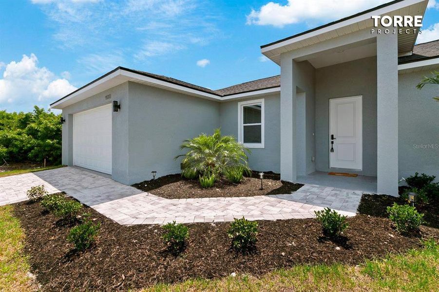 Front exterior of a new home in , Port Charlotte, FL, highlighting curb appeal (Image 10).