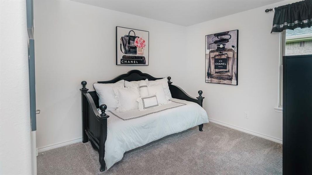 Carpeted room with a window featuring white trim