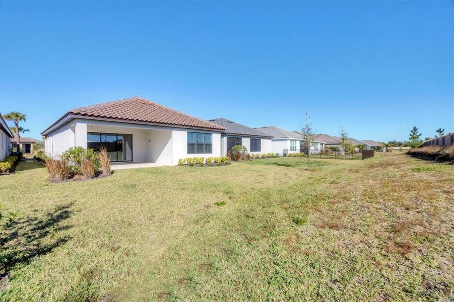 Exterior details and patio area of a home in Esplanade at Artisan Lakes, Palmetto (Image 24).