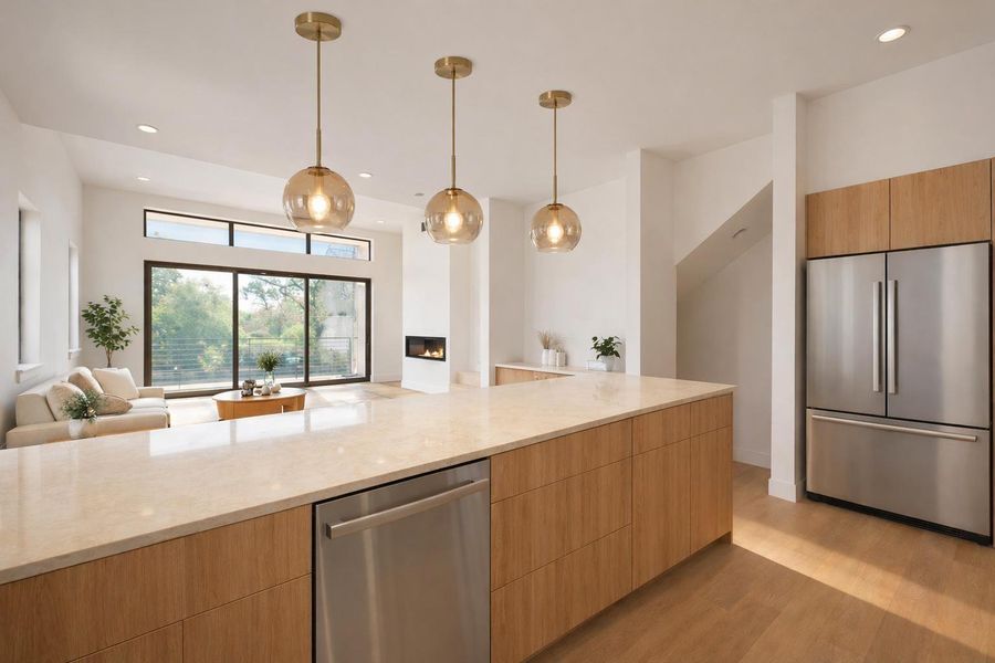 Bright and functional kitchen featuring a quartz island, abundant cabinet storage, and plenty of natural light, designed for both everyday living and effortless entertaining.