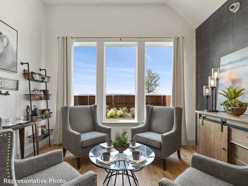 Living area with wood finished floors and vaulted ceiling Living area with wood finished floors and vaulted ceiling