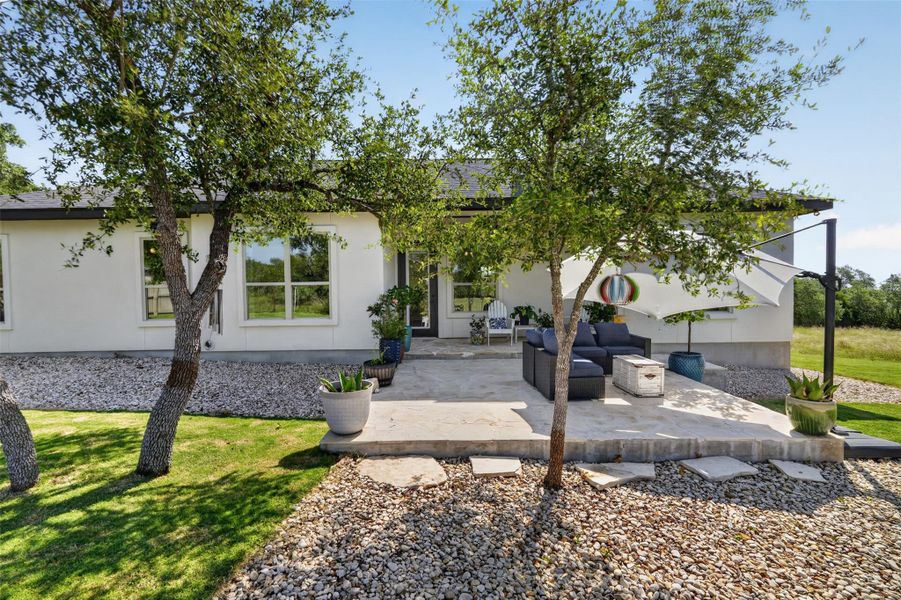 Peaceful backyard ideal with a covered stone patio, and large trees Peaceful backyard ideal with a covered stone patio, and large trees
