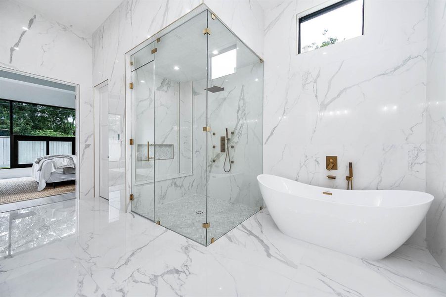 Primary bathroom showcasing a spacious primary shower alongside a soaking tub.