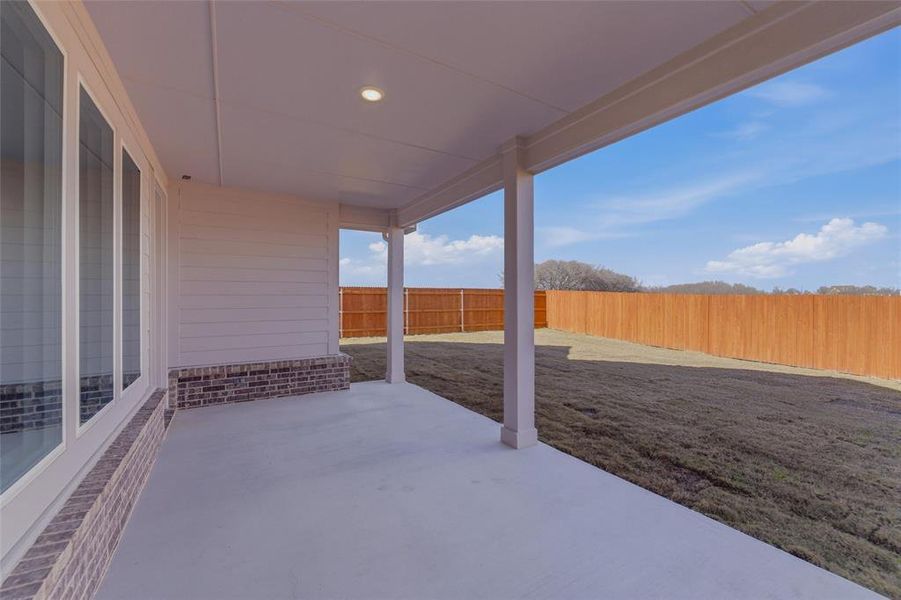 Fenced backyard with a patio area