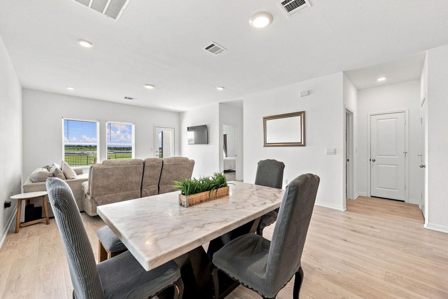 An open floor plan connects the dining space with the main living area.